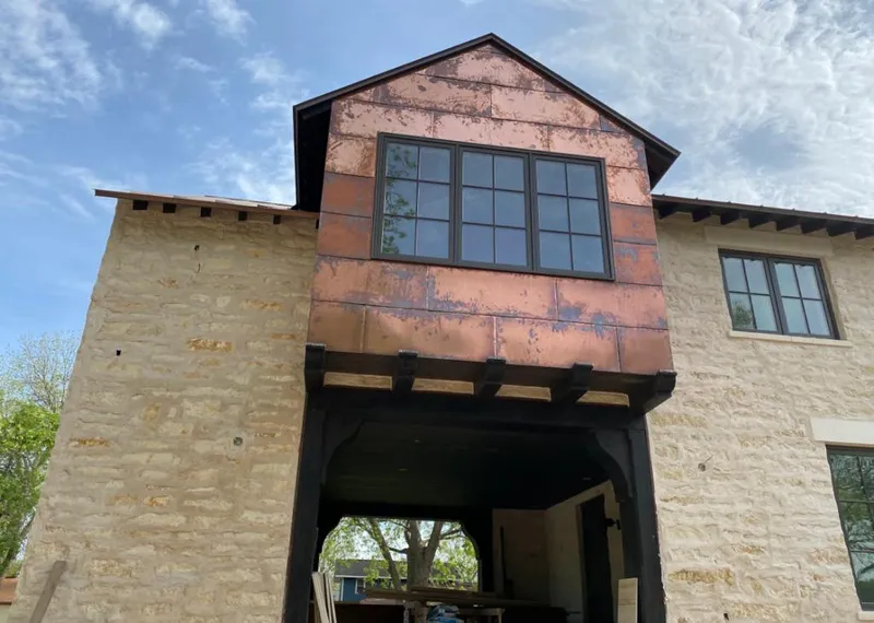 Copper metal panel facade on a stone building for Skylight Installation in Kasson
