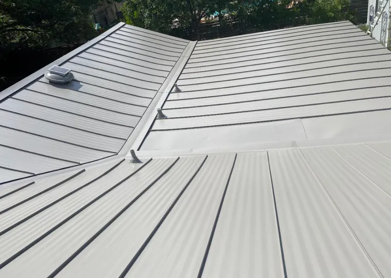 Solar attic fan installed on a metal roof for Roof Ventilation in Kasson